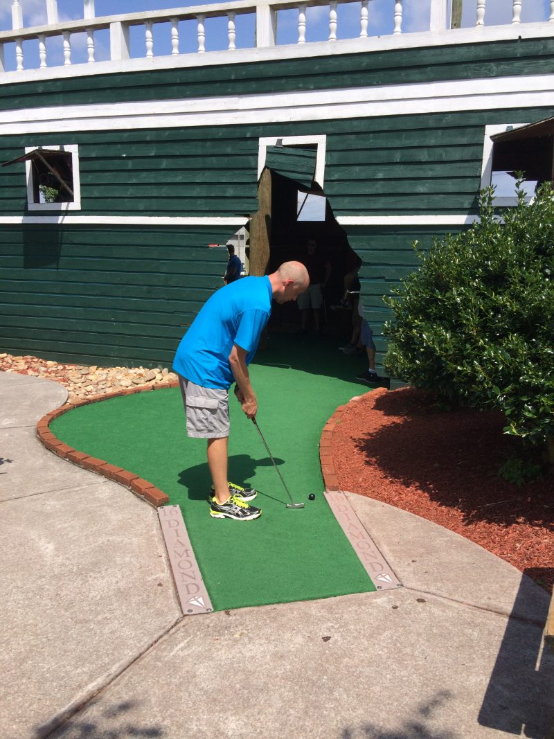Troy standing over a putt